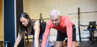 Your guide to Senior Citizens Health and Exercise Senior man exercising on a mat with a woman trainer