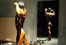 Mirror, mirror on the wall – who has the best physique of all? Bodybuilder posing in front of a mirror