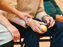 Alzheimers patient holding a ball for therapy