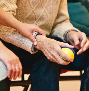 Alzheimers patient holding a ball for therapy