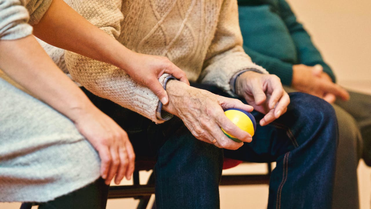 Alzheimers patient holding a ball for therapy