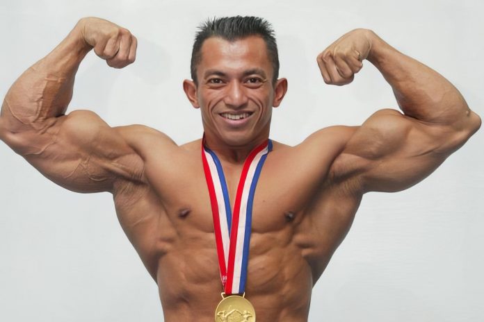 Bodybuilder with medal doing a double bicep pose