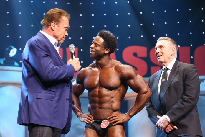Arnold with 2018 Arnold Classic Men's Physique winner Breon Ansley and IFBB Pro League President Jim Manion photo by Dave Emery