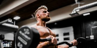The Ultimate Guide to Beginner Bodybuilding in 2024 Bodybuilding with barbell curls. Photo by Anastase Maragos on Unsplash