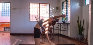 Mastering the Basics: Essential Fitness Equipment for Home Workouts A woman doing a yoga pose at home
