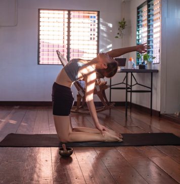 A woman doing a yoga pose at home