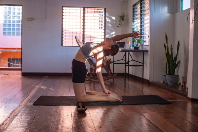 A woman doing a yoga pose at home