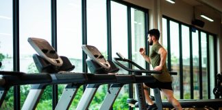 Bodybuilding for Busy Professionals: Quick Workouts for Maximum Impact! Bodybuilding for Busy Professionals. Man running on a threadmill in a hotel gym