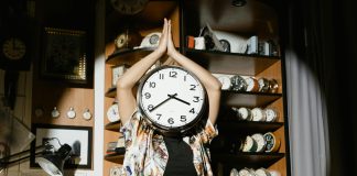 Why It Is Important to Have a Regular Exercising Schedule regular exercising schedule. Woman with a Clock Head Doing Yoga in a Watch Repair Shop