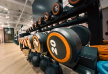 Progressive Overload: The Key to Building Muscle Efficiently progressive overload Close-up of Dumbbells in Modern Gym