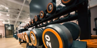 Progressive Overload: The Key to Building Muscle Efficiently progressive overload Close-up of Dumbbells in Modern Gym