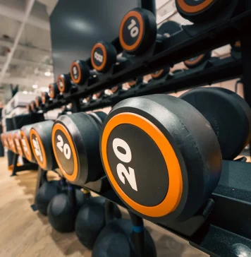 progressive overload Close-up of Dumbbells in Modern Gym