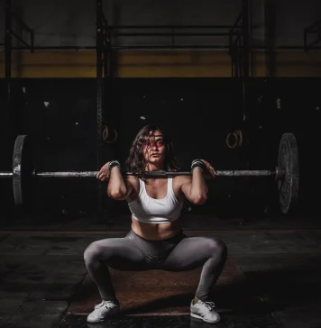 Strength vs. Hypertrophy Training: What's the Difference? A woman doing powerlifts